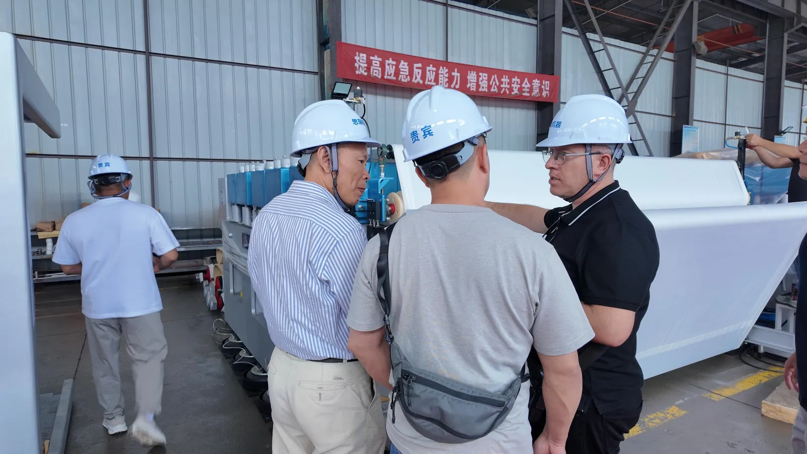 SREE engineers explaining a machine to Kyrgyz visitors in the assembly shop