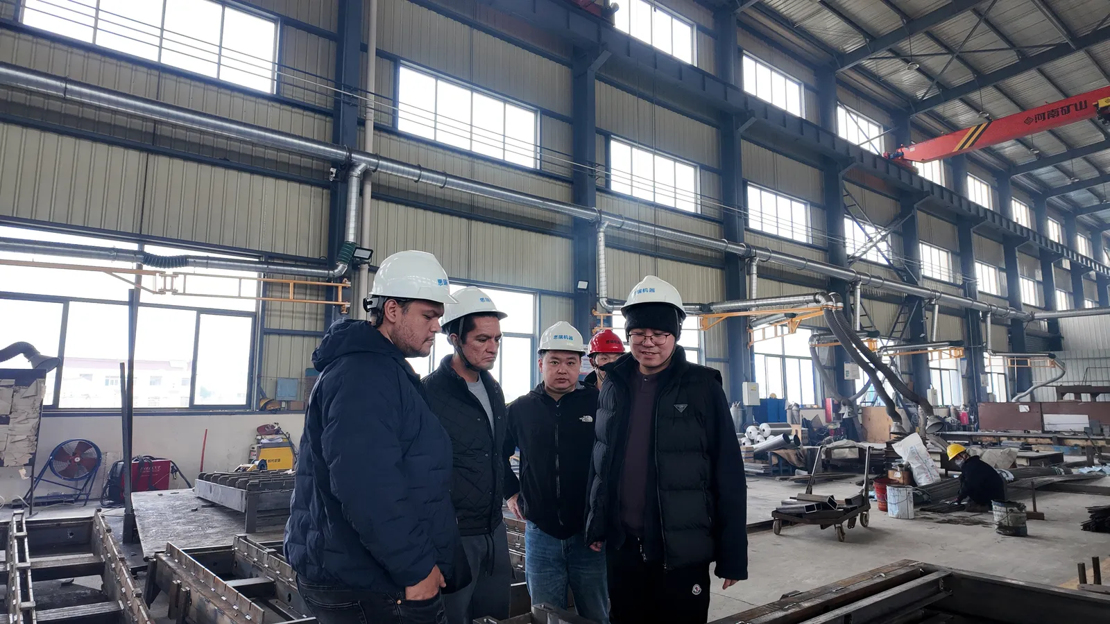 Mexican visitors talking with SREE staff in the fabrication workshop